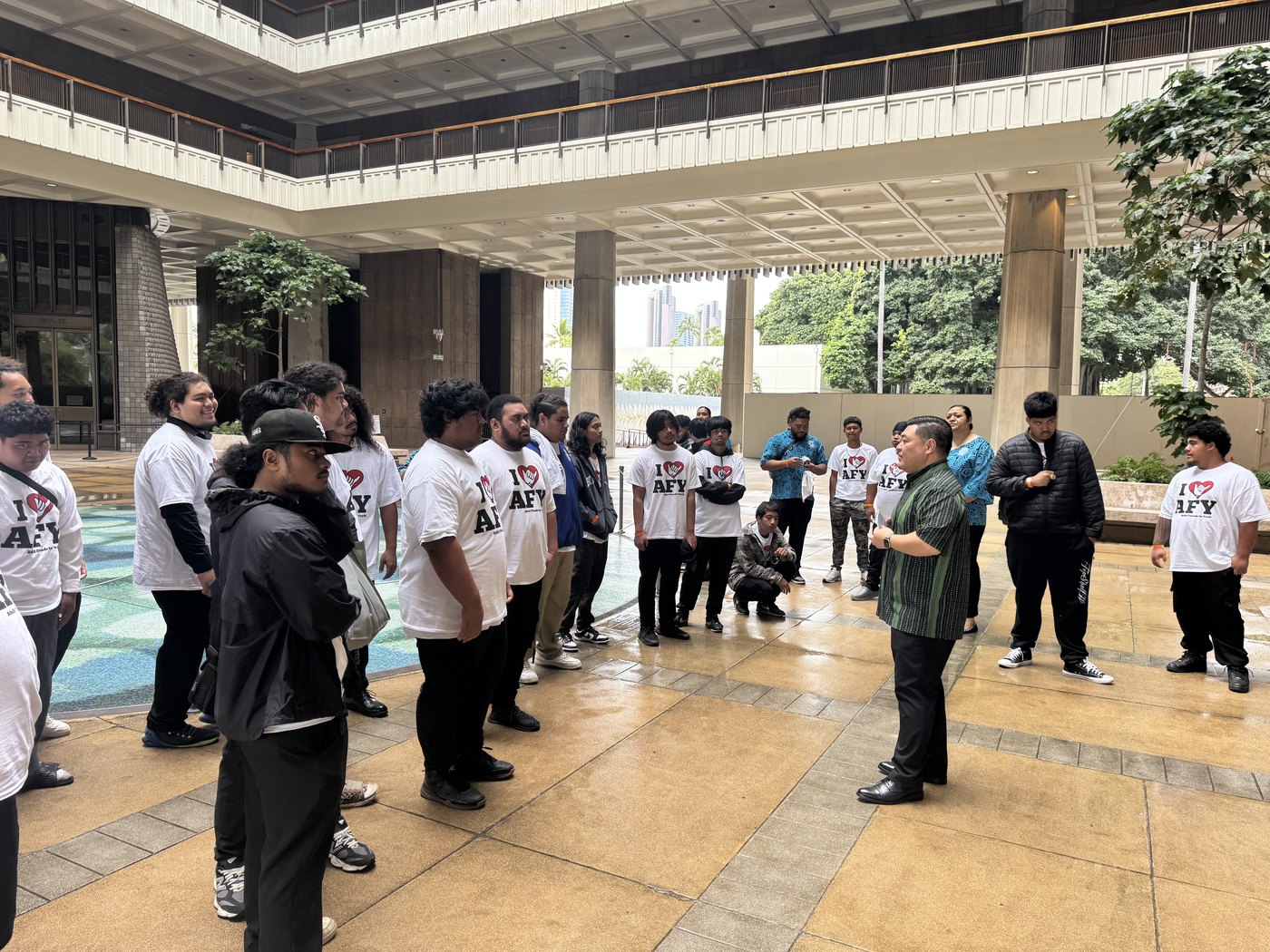 Tyson Miyake with community members in a public gathering space