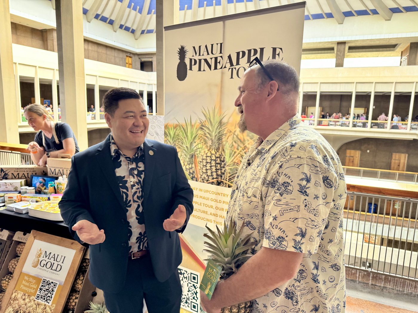 Tyson Miyake talking with a local business representative