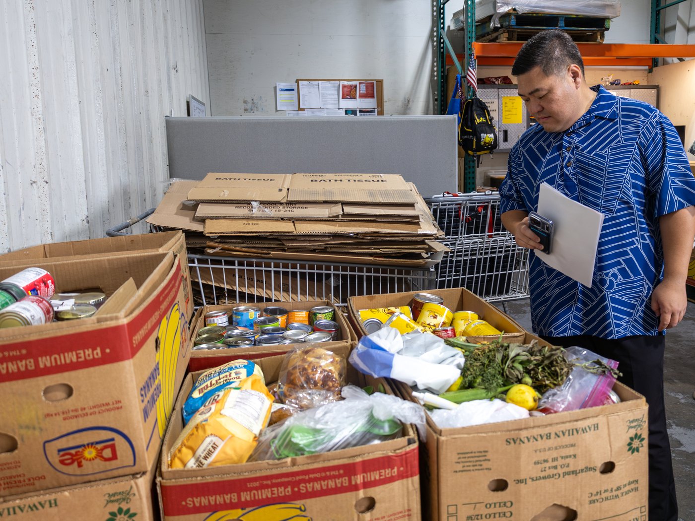 Tyson Miyake near boxes of local food supplies