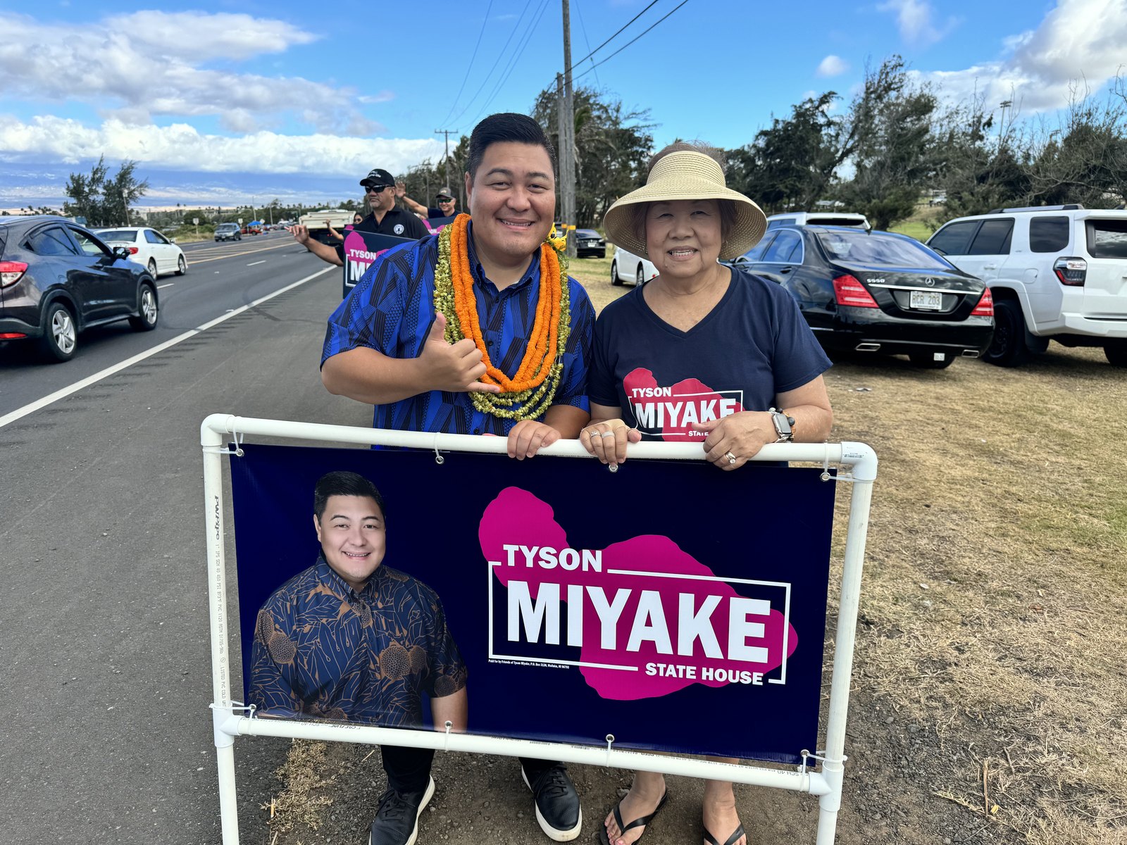 Tyson Miyake speaking with residents at an outdoor event